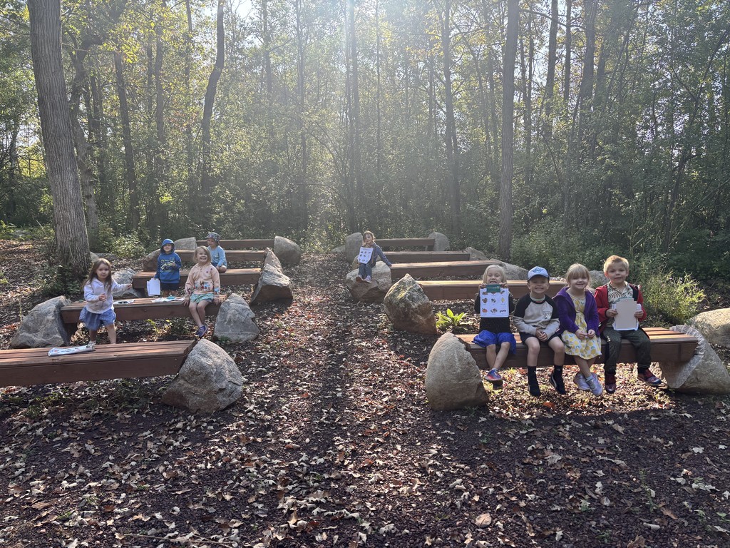 preschoolers sitting on the outside classroom benches