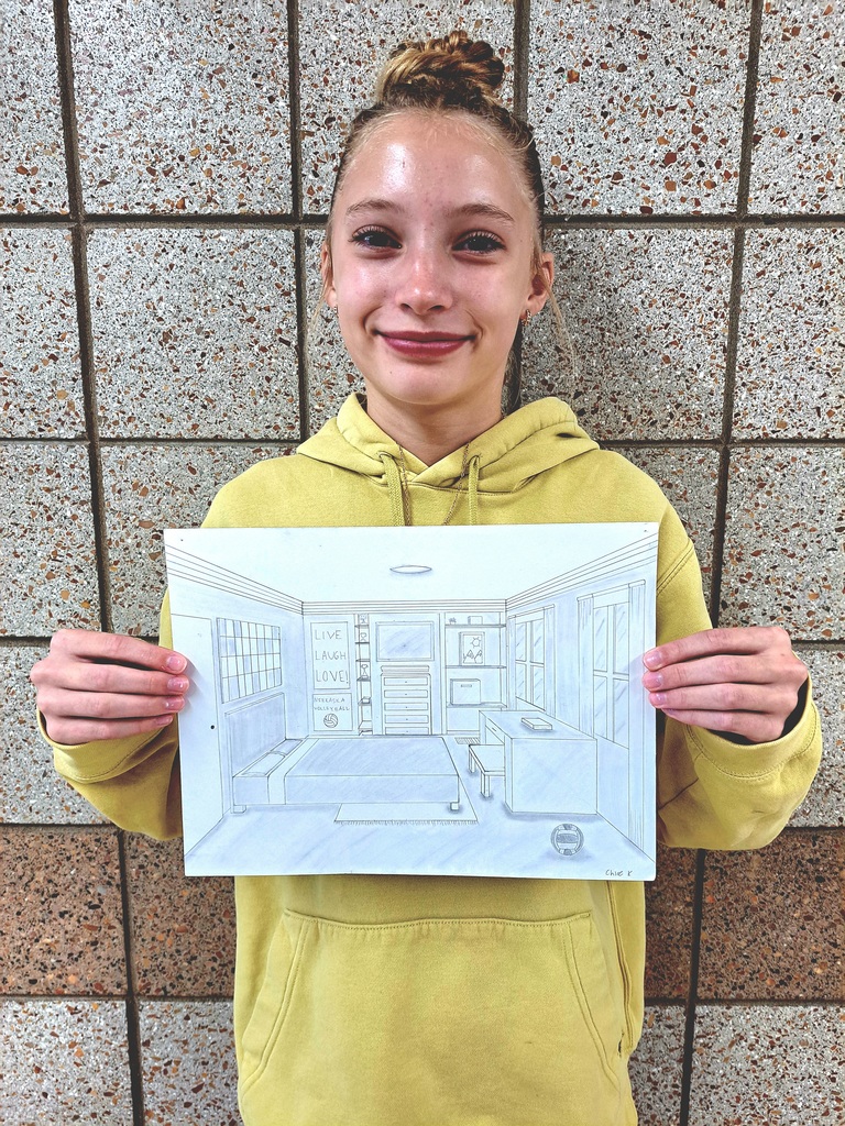 Female 8th grade student holding a 1-point perspective drawing