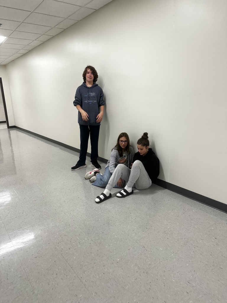 three students working together on an anti-bullying video
