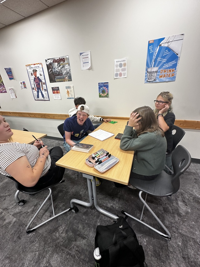 students sitting at a table working together on their anti-bullying project