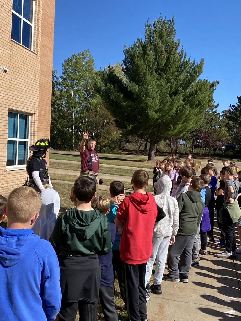 Fireman and firewoman speaking to students at CRES