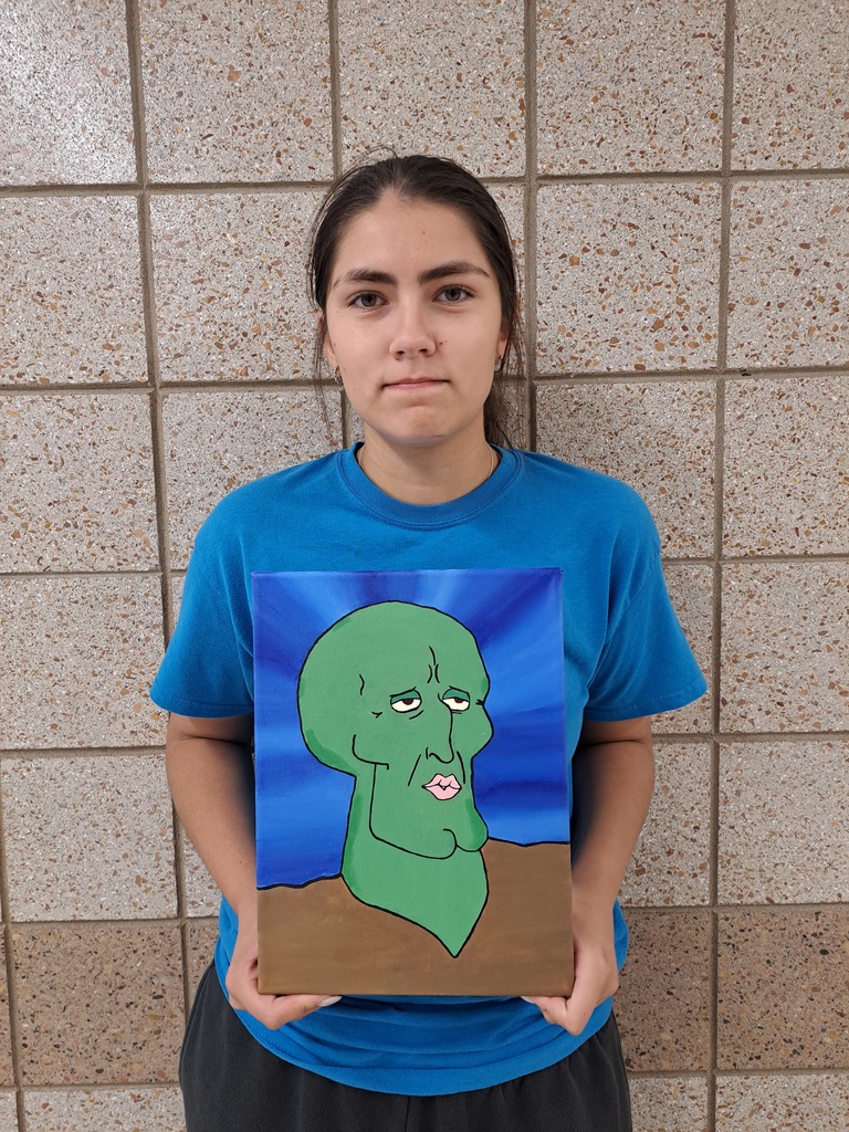 Female student holding a painting of a handsome Squidworth from Sponge Bob Squarepants