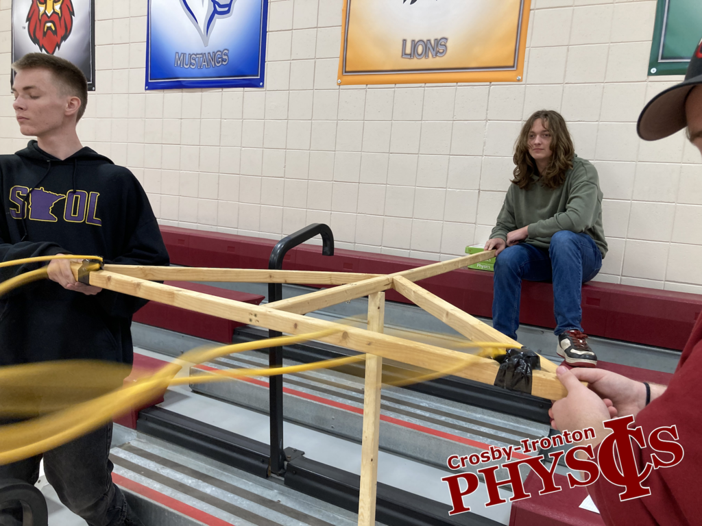students holding a giant homemade sling shot