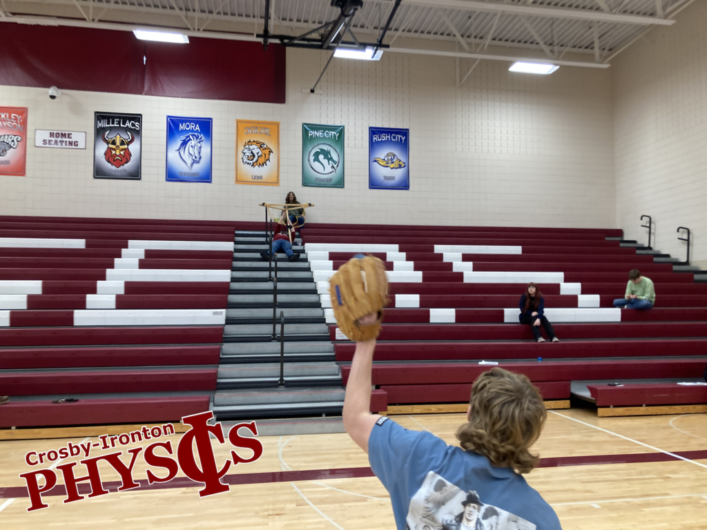 Student with a baseball glove ready to catch the ball thrown by slingshot