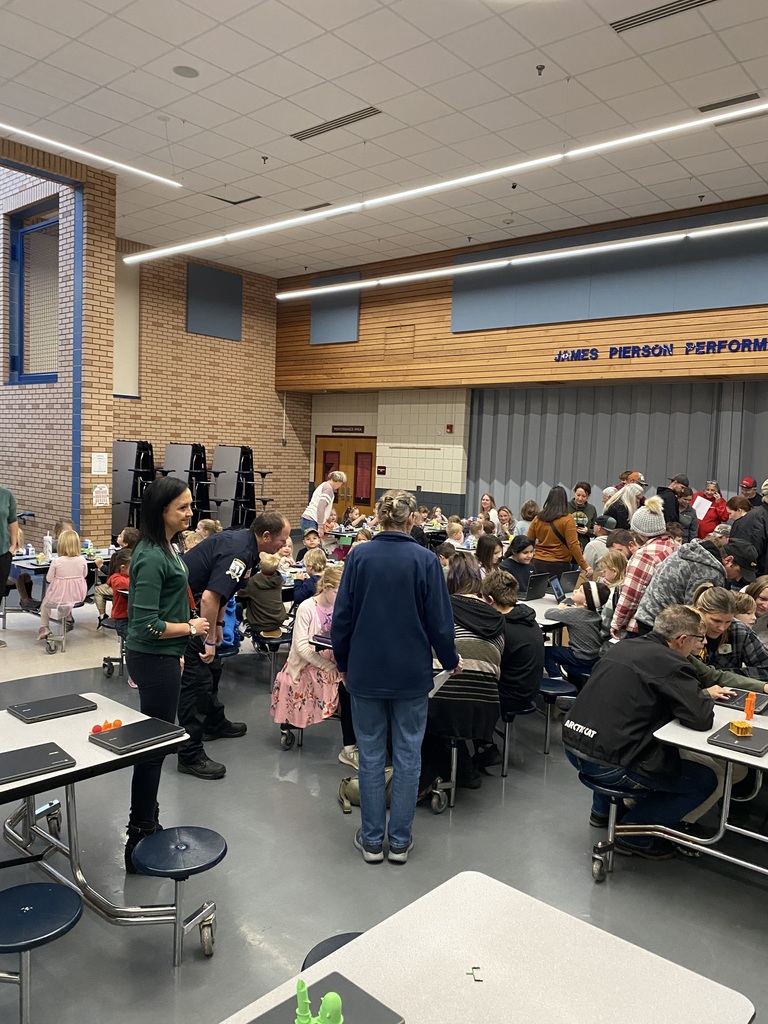 parents and students in the CRES cafeteria going over their students STEM Expo