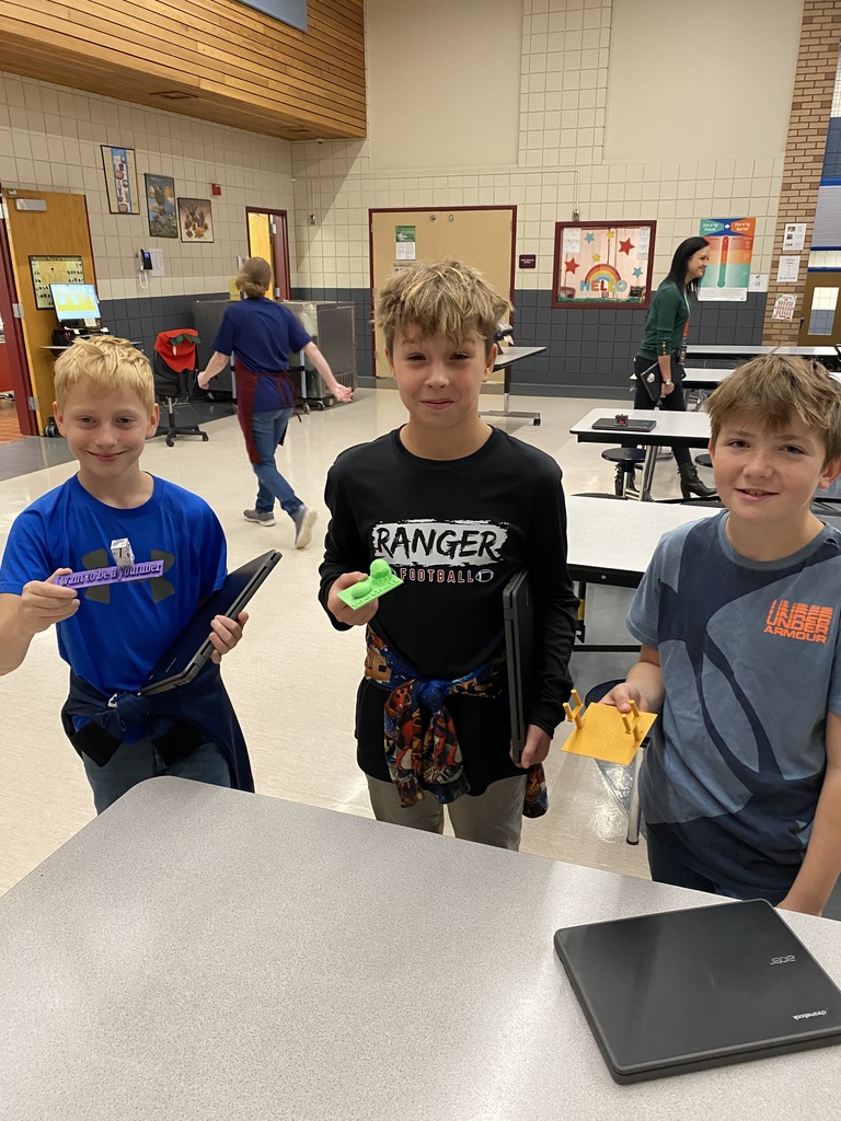 5th grade students holding their 3D prints for their expo