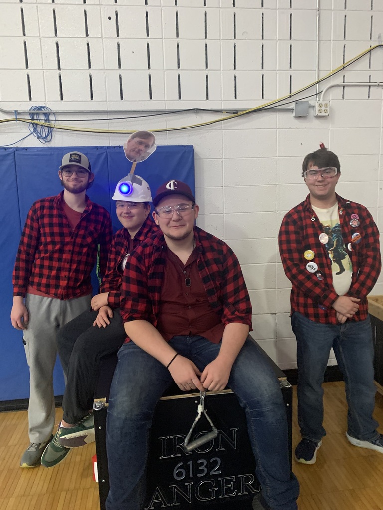 Robotics students in red and black flannel shirts