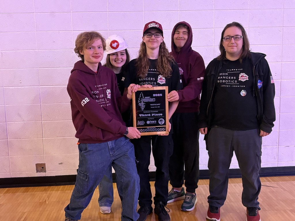 Robotics students holding their third place trophy!