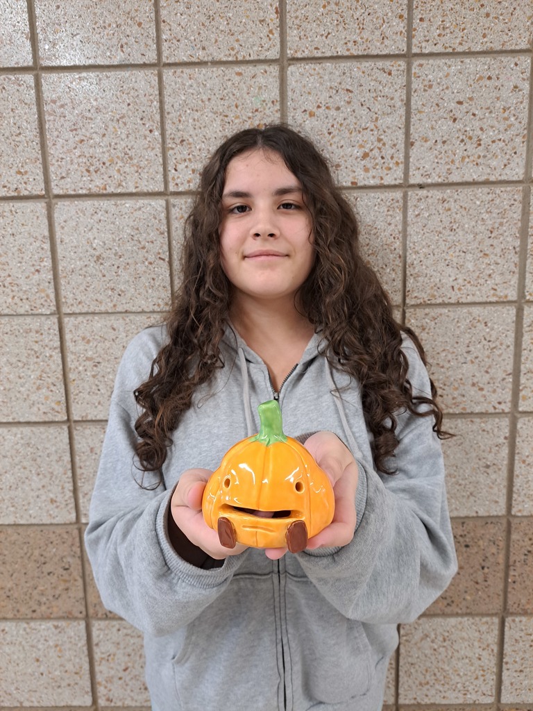 Rhiannon holding a pumpkin tea light