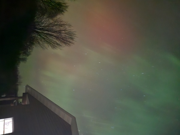 the northern lights shining green and pink
