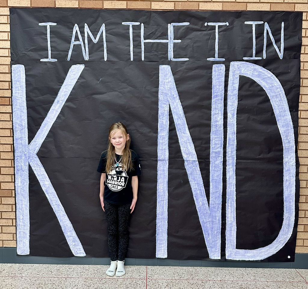 Female student posing at the letter "I" in the word Kind at CRES