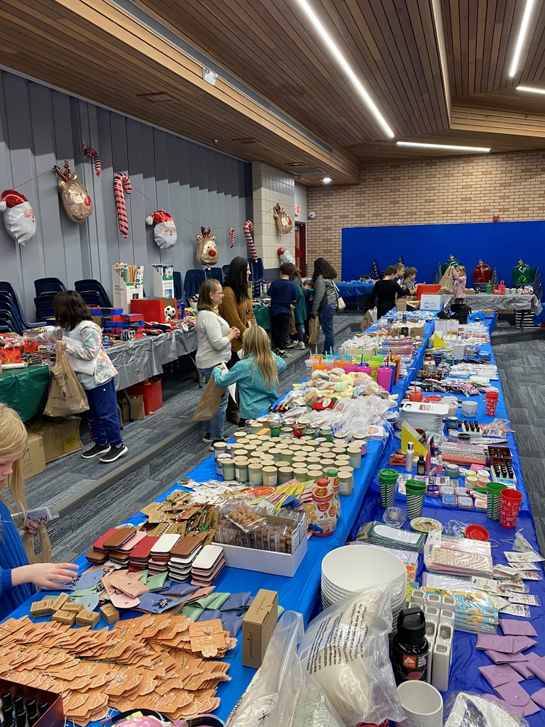 Tables full of items for students to choose as gifts for their family at Jingle Bell Lane