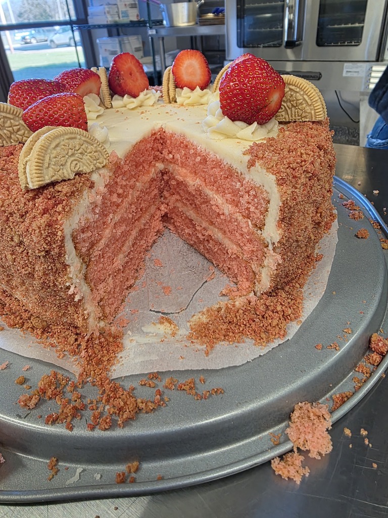 strawberry layered cake with strawberries and vanilla cookies that a culinary group made