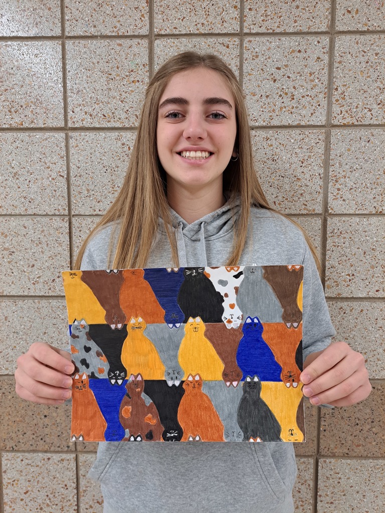 female student holding a cat tessellation drawing with blue, yellow, brown, orange and gray cats