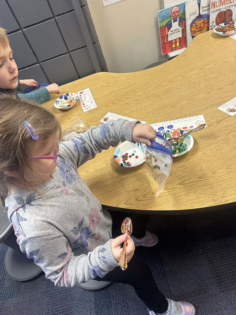 female student putting colored m&ms into a baggie