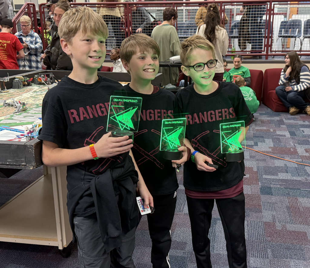 The Rangers lego members holding their awards at lego league tournament