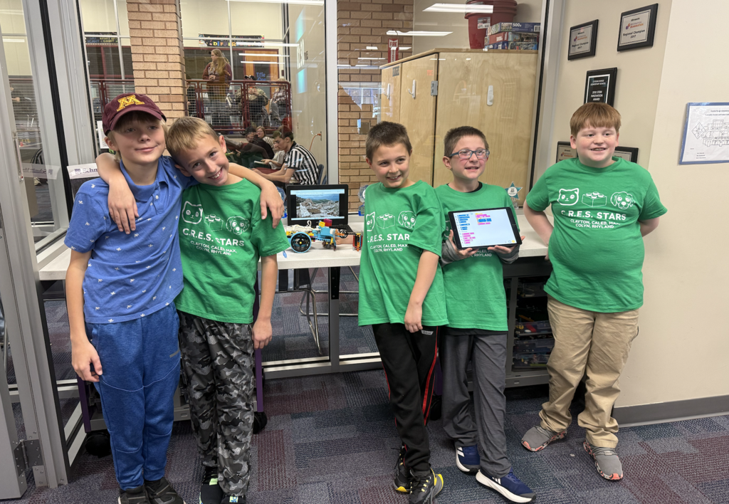 5 lego team members 4 in shirts that say CRES Stars and one in a blue polo