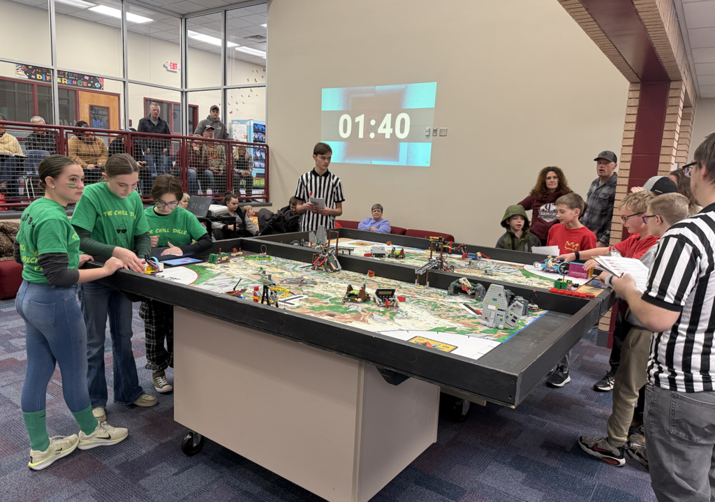 Two Lego league teams compteting at CRES. One team wearing green the other wearing red
