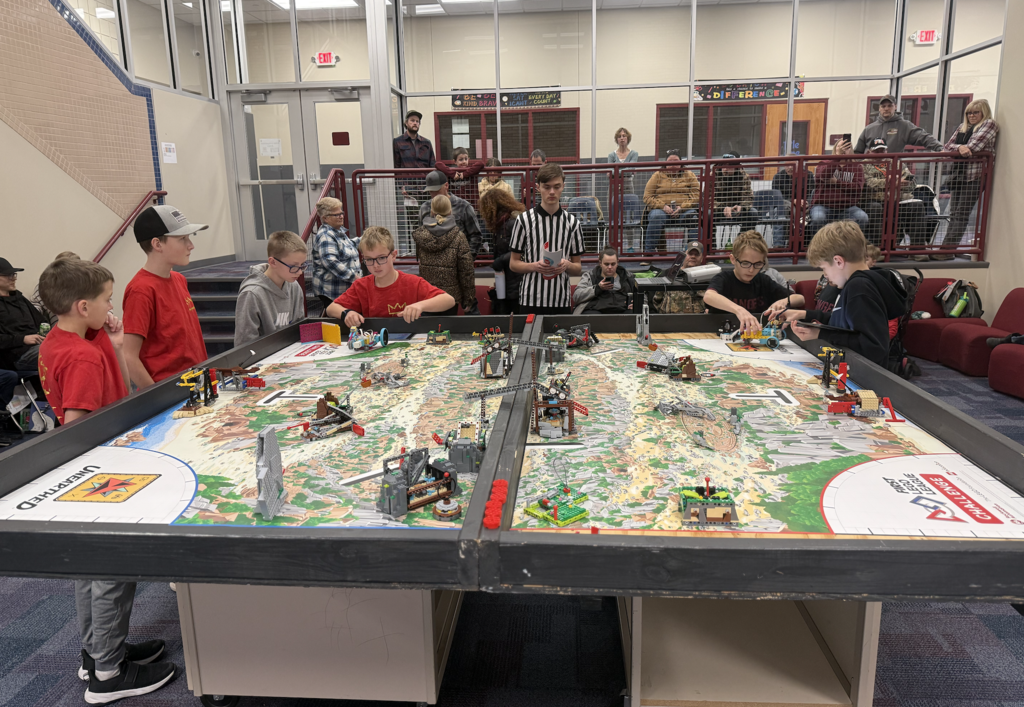 two lego league teams competing against one another, red team vs rangers