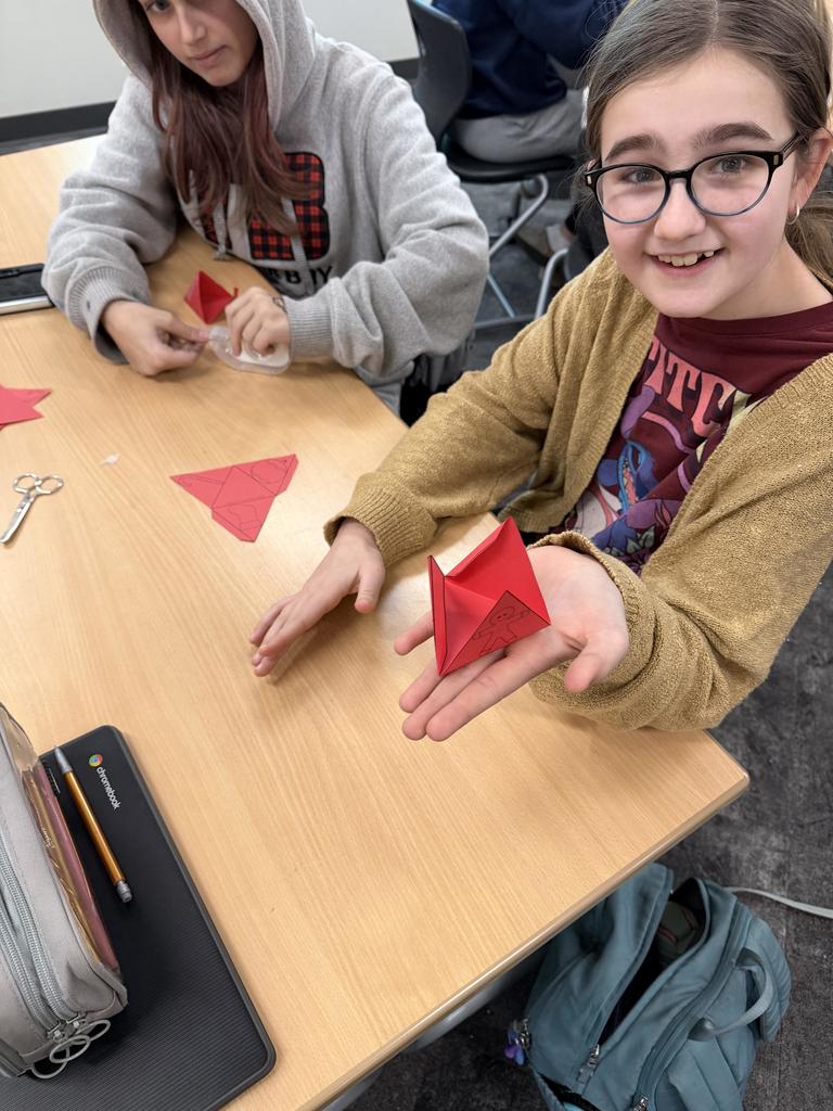 a female student holding a Serpinski triangle in her hand