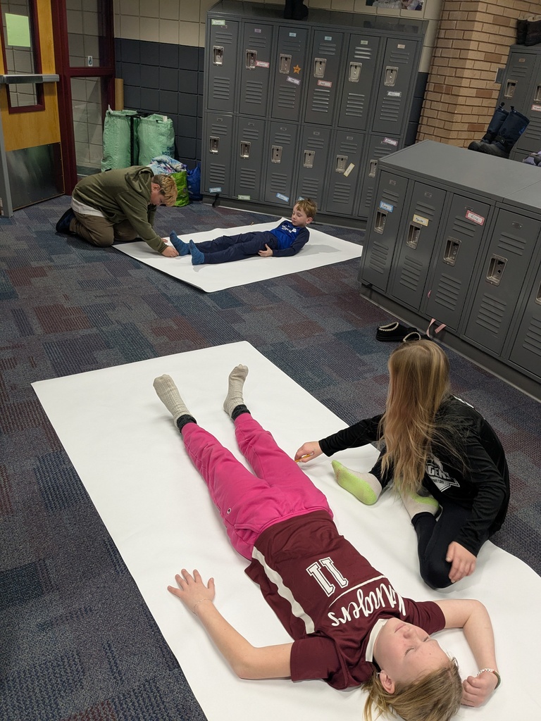 male and female students tracing each other for their how the body works chapter