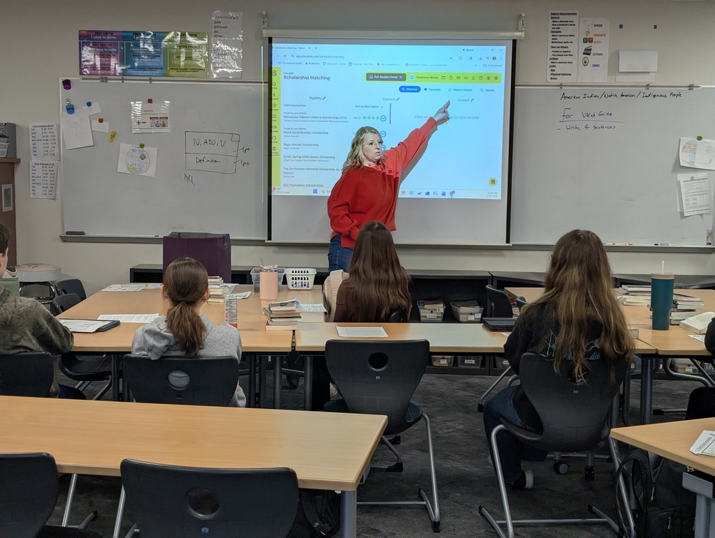 Mrs. Doyle pointing at the board showing students in practical writing how to apply for scholarships