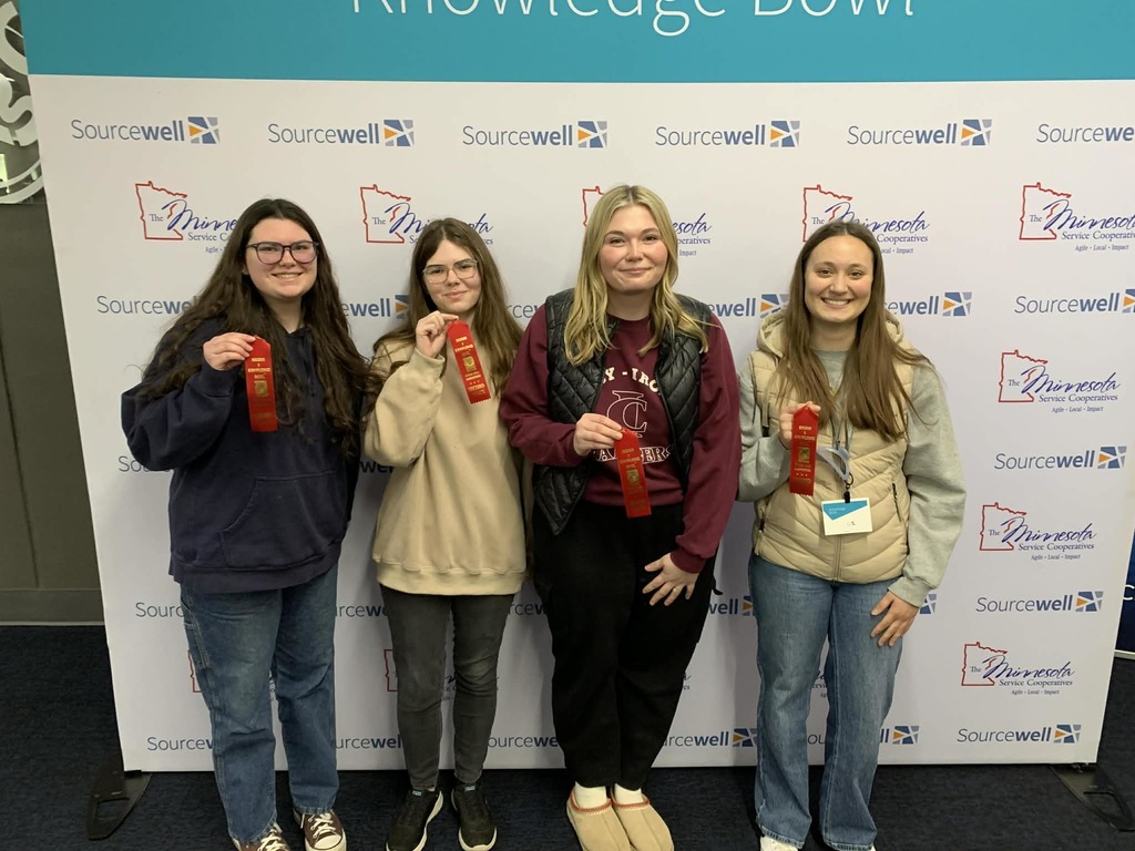 4 female juniors holding second place ribbons at Knowledge bowl