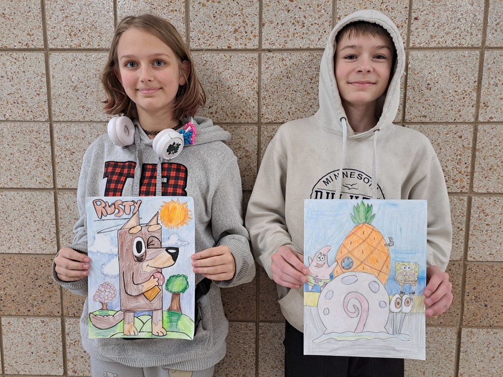 Female studetn holding a cartoon drawing of Rusty and a male student holding a cartoon drawing of Sponge Bob 