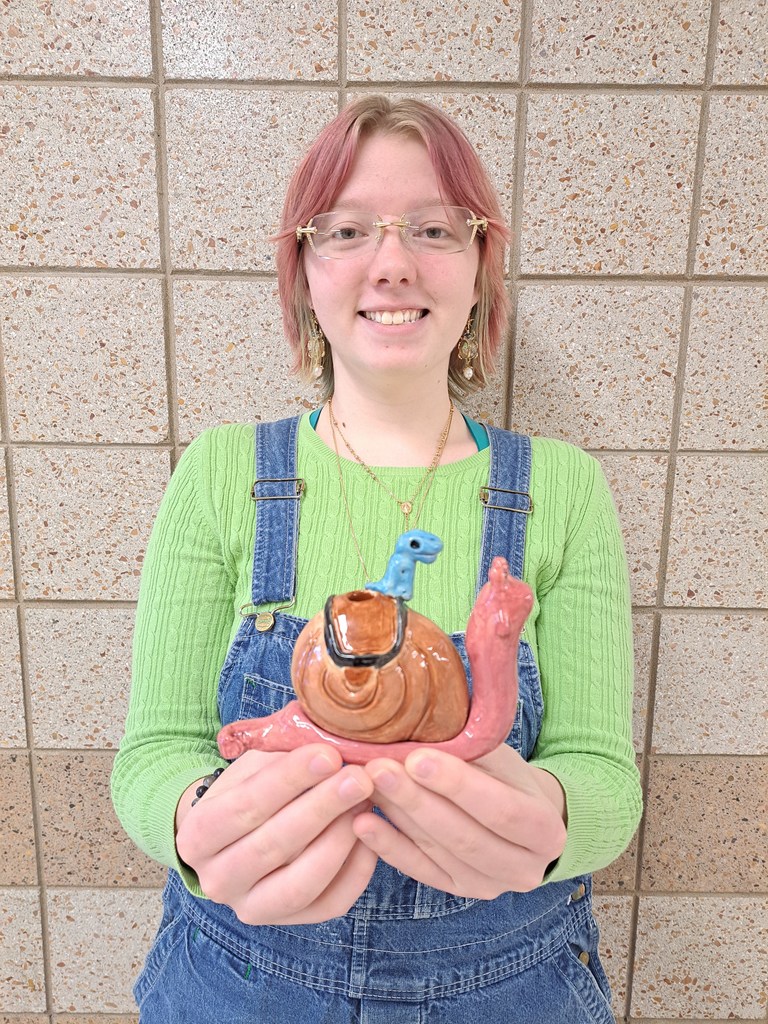female student holding her 3D creation of a snail