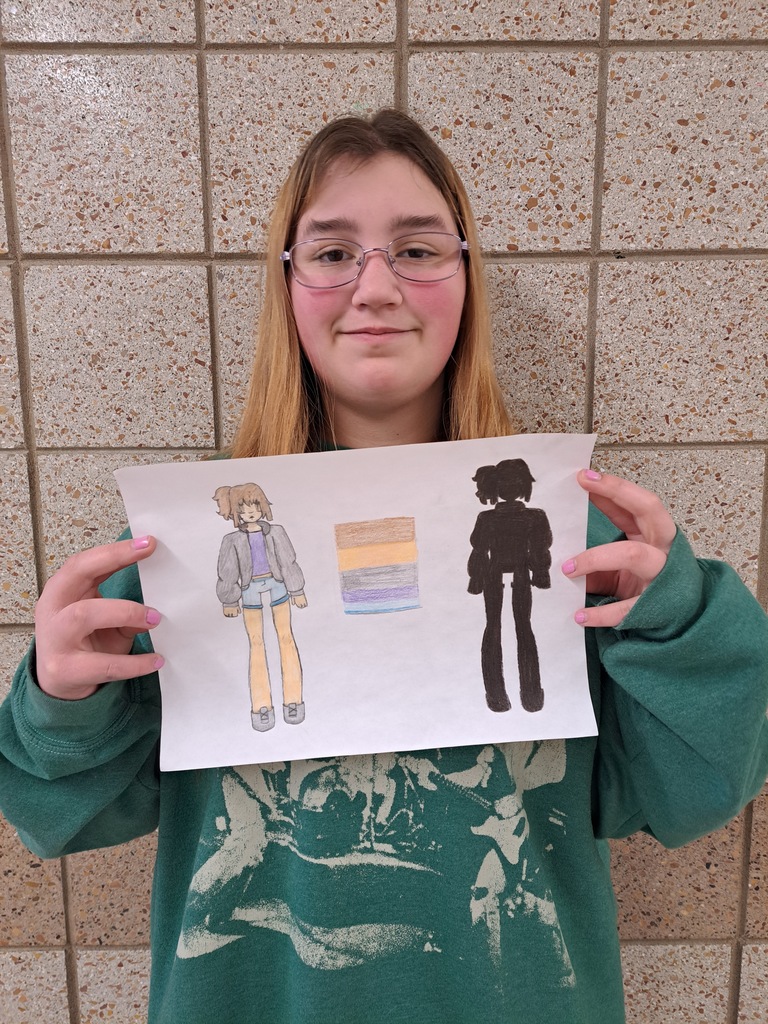 Female student hold a drawing of a a girl in all black and onion color