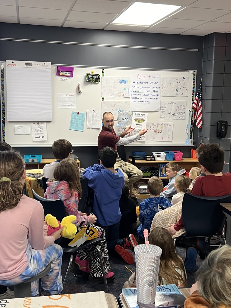 Superintendent Aulie reading a book to 3rd grade students