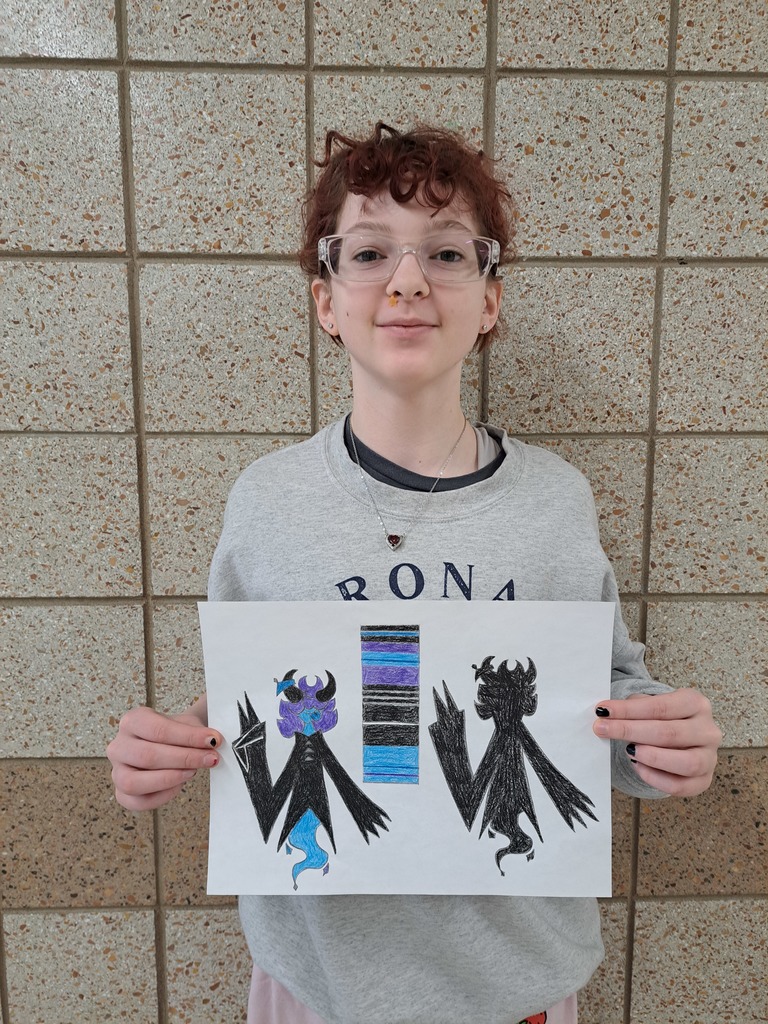 student holding a drawing of a comic illustration