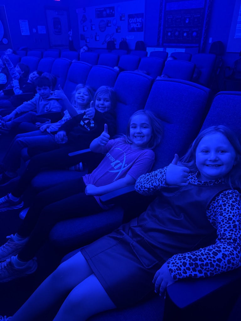first graders giving a thumbs up to the planetarium at Forestview