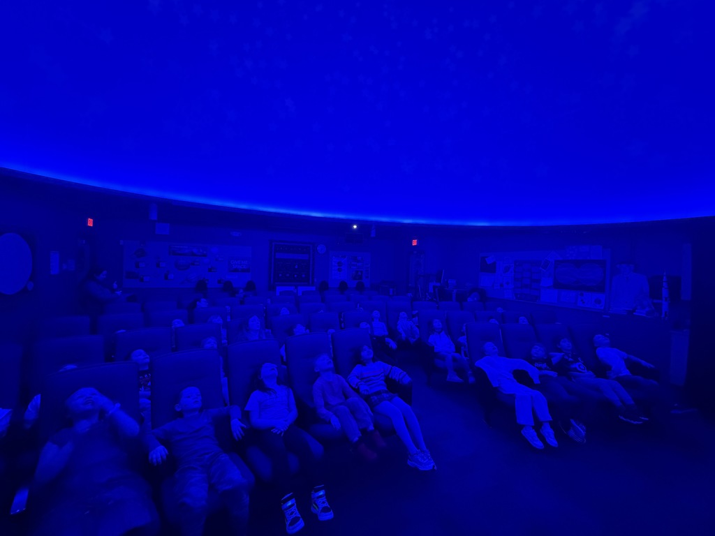 many of the first graders sitting in the planetarium seats at Forestview
