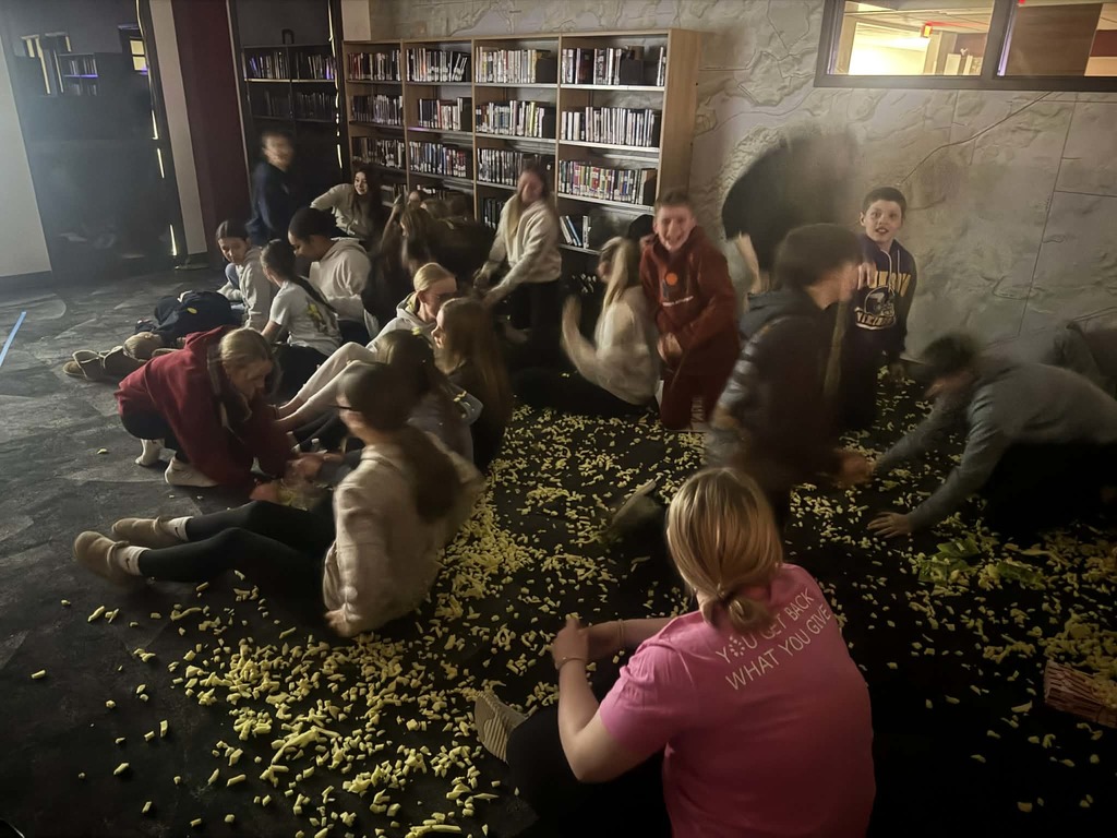 7th graders picking up what looks like yellow pollen