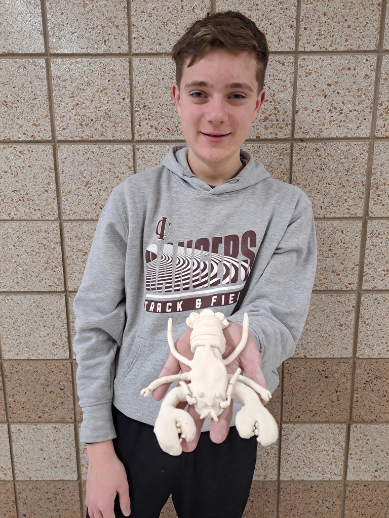 male student holding a 3d lobster creature