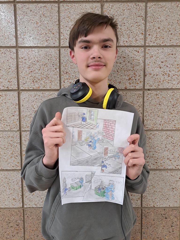 male student hold a 5 panel comic that he drew by hand with pencil and colored pencil