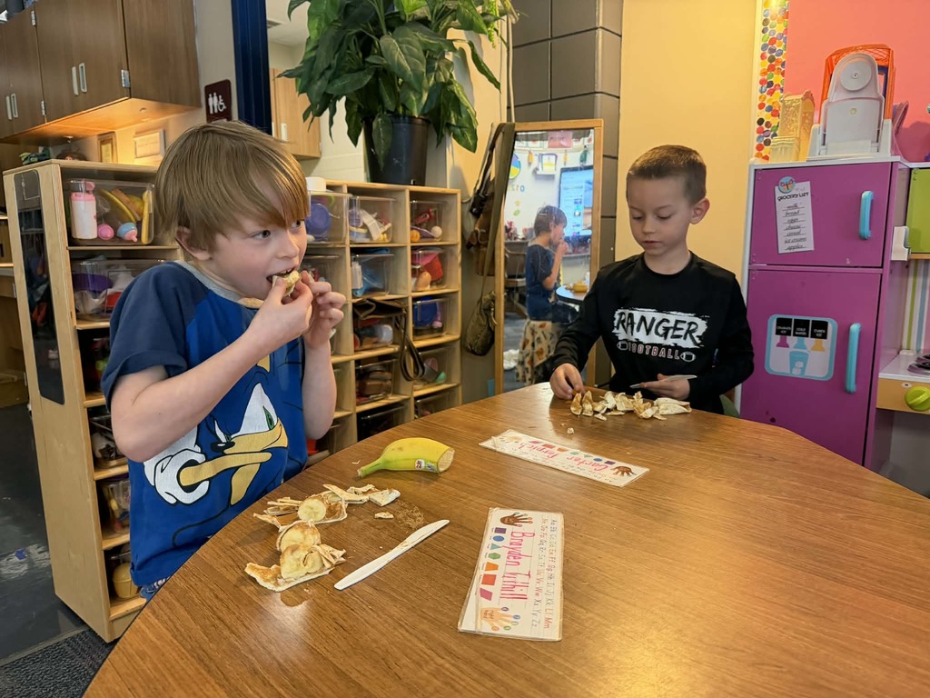 two boys eating their peanut butter banana sushi