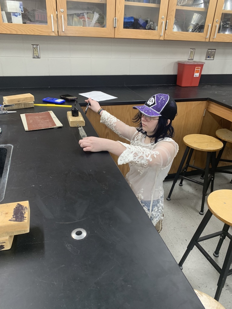 student working on her friction lab in science class
