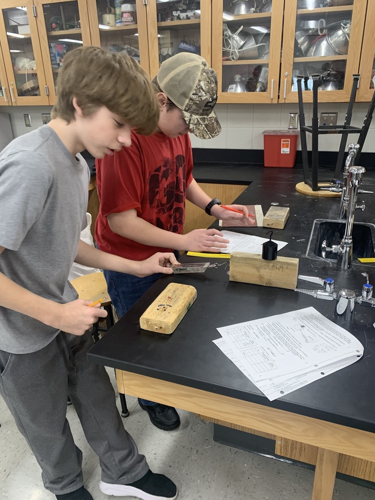two male students working on their friction lab in science