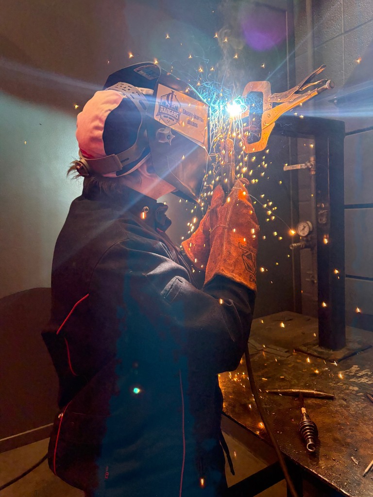 student in advanced welding working on a T joint weld