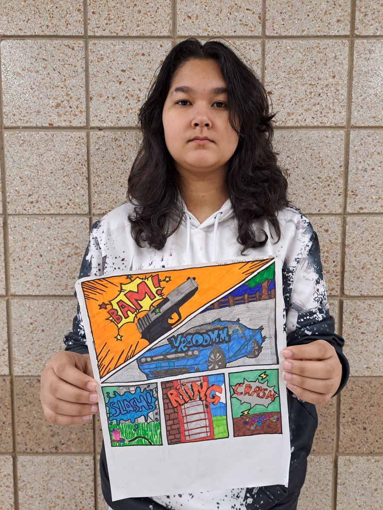 Student holding a sfx comic drawing