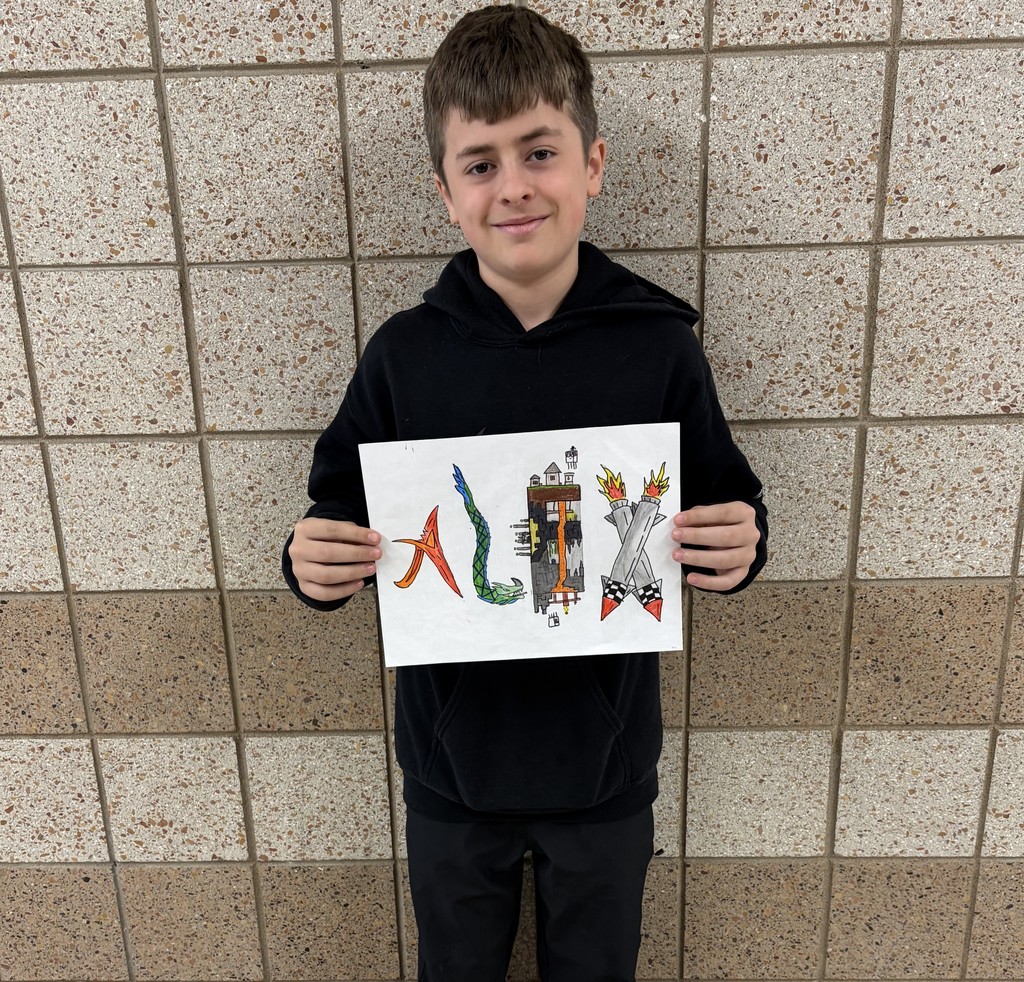 male 7th grader holding his rendition of his name in art form