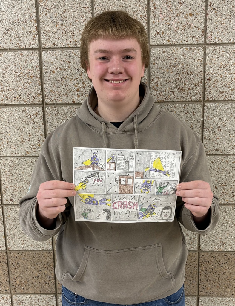 male artist of the week holding a comic strip that he drew and colored