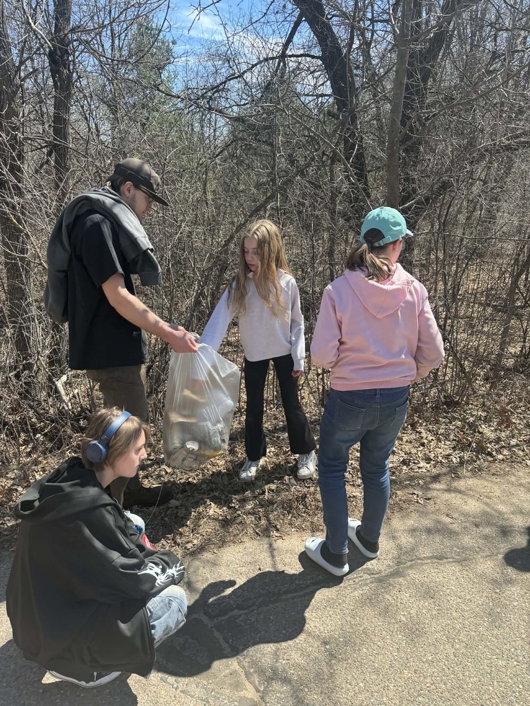 students picking up garbage and putting it in garbage bags