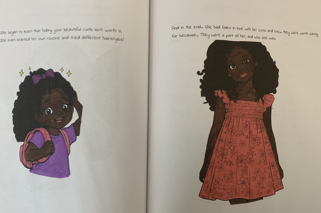 two pages from one of the published books of a beautiful african american girl who didn't like her curls but learned to love them