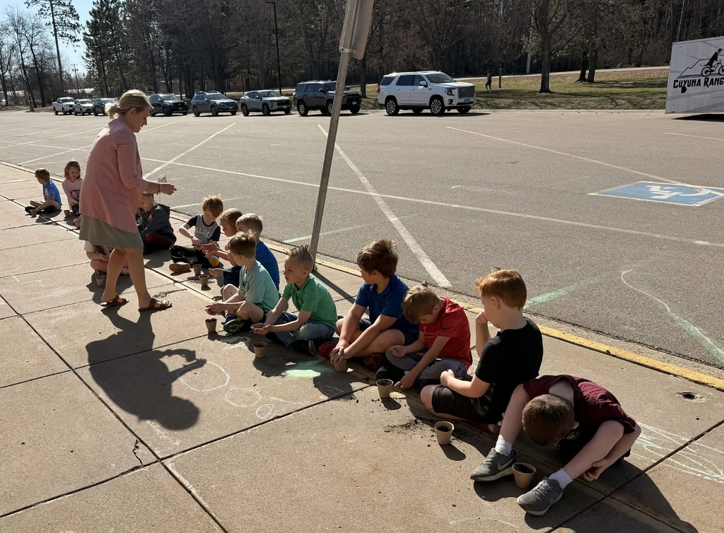 Miranda Larson handing out seeds to kindergartners