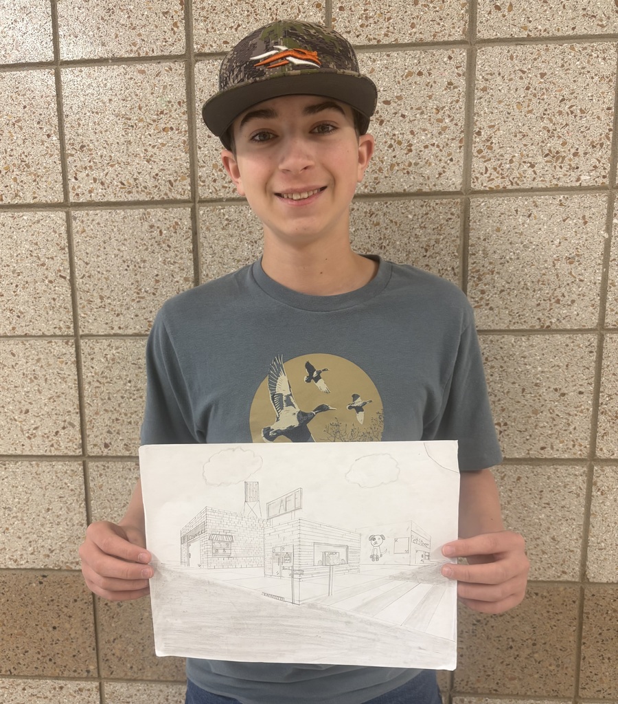Male student holding his 2 point perspective drawing 