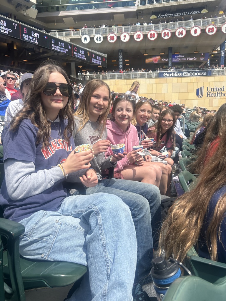 8th grade girls posing with their dip n dots at the MN Twins game