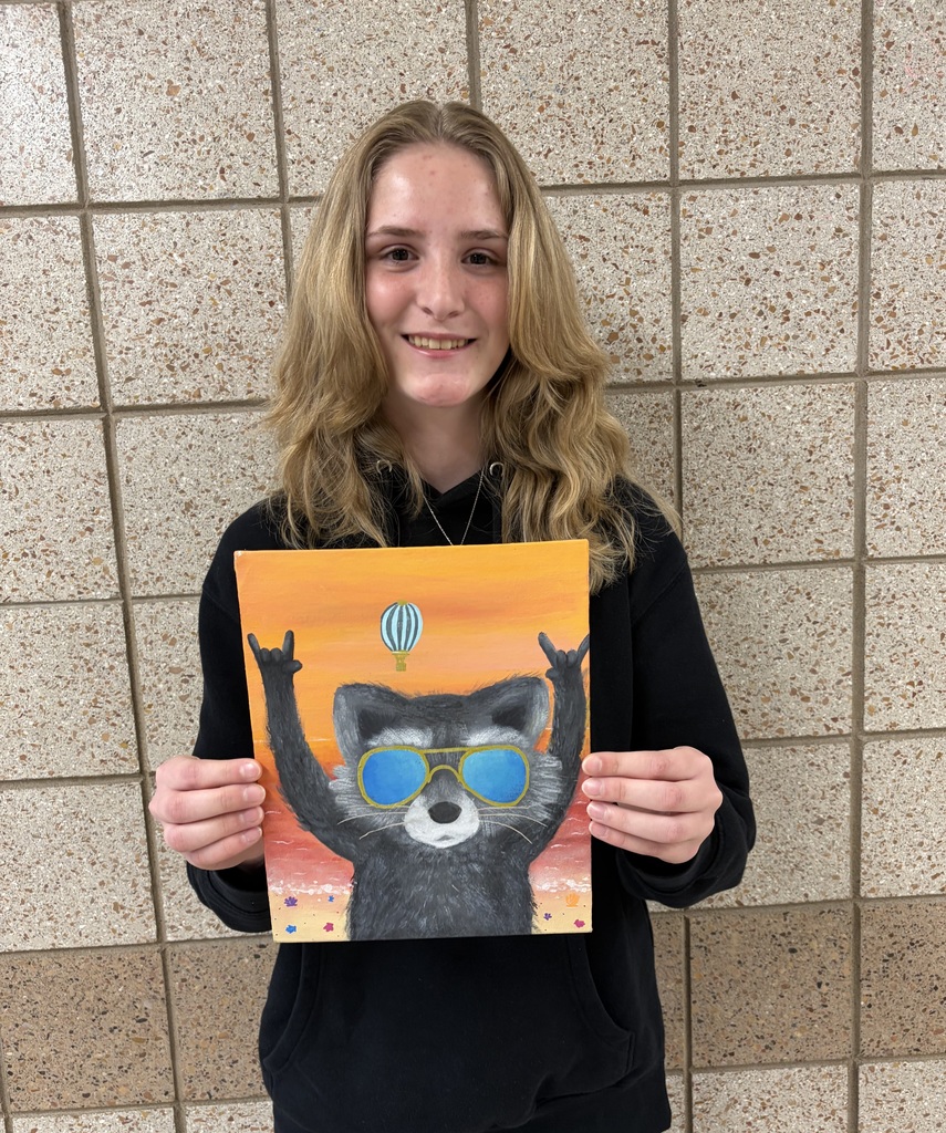 9th grade female holding a painting of a racoon giving the "rock on" sign with it's hands